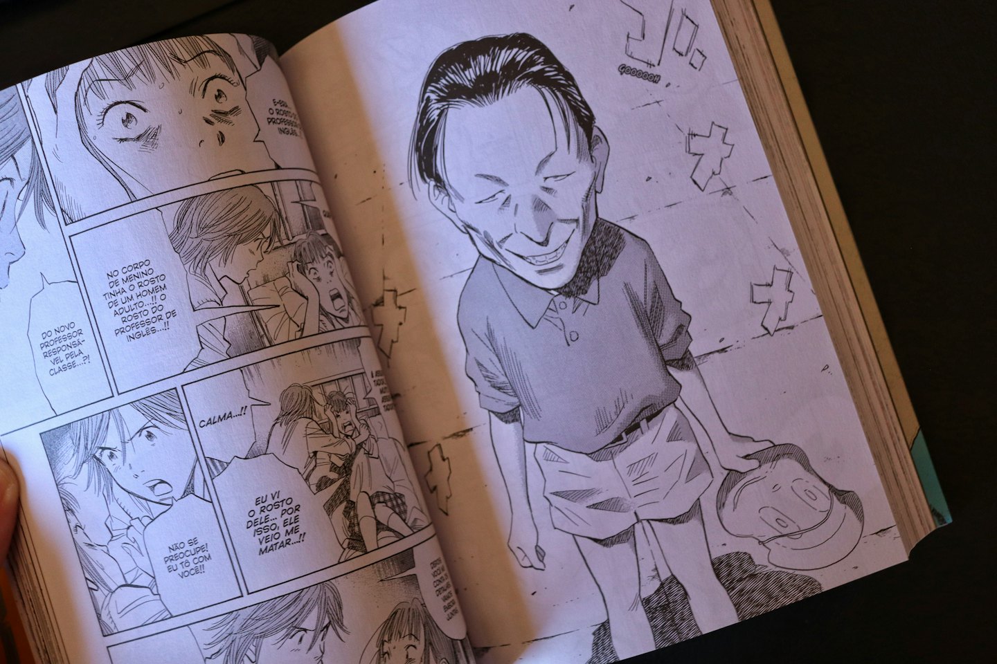 Open manga book displaying detailed black and white illustrations.