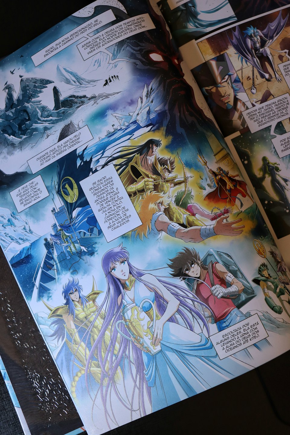 Open comic book pages displaying colorful fantasy action illustrations.