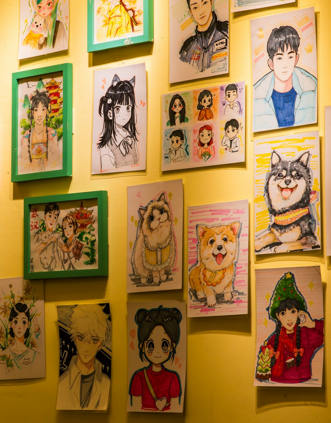Cartoon illustrations and portraits displayed on a yellow wall.